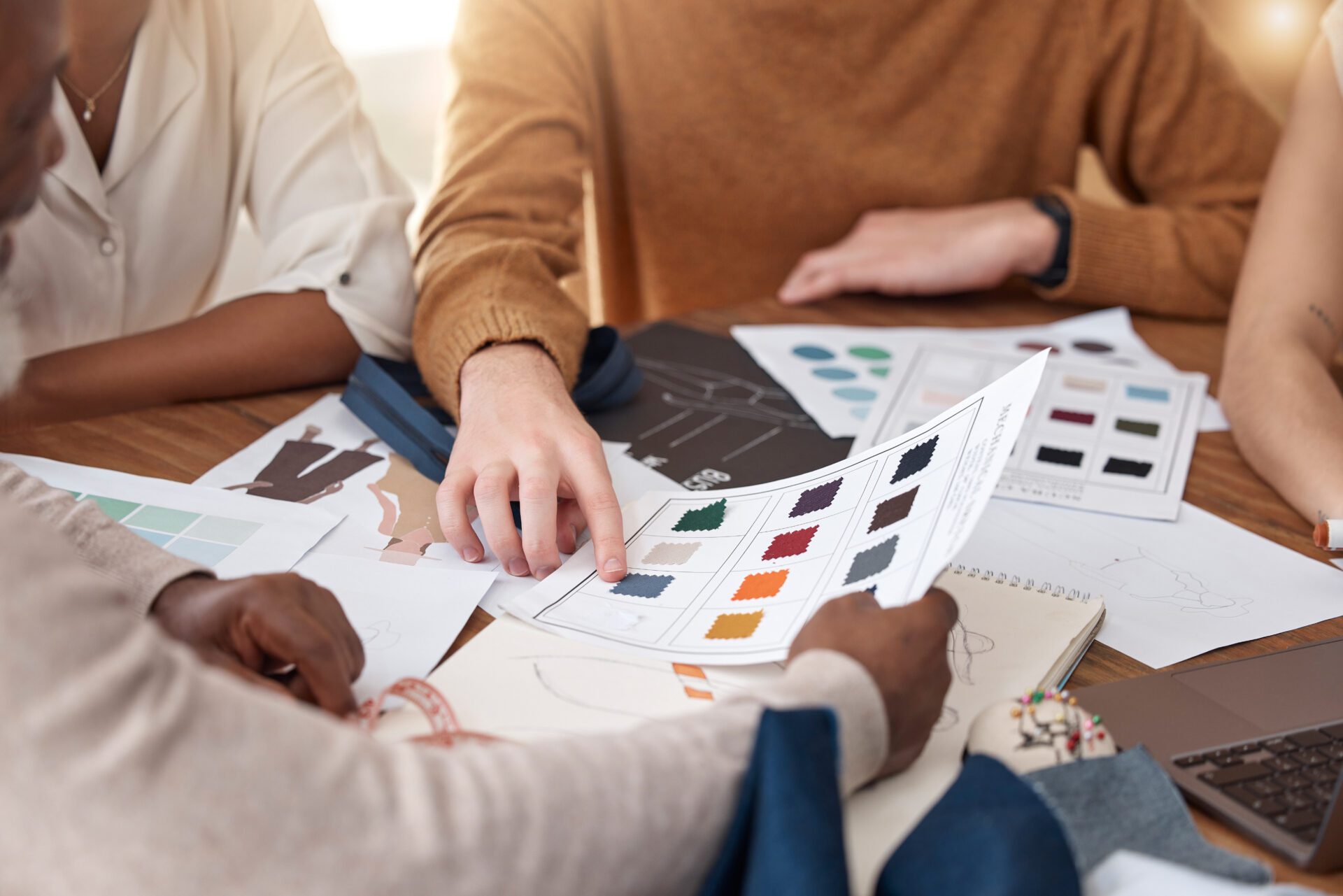 Fashion, design and planning, team in meeting with ideas for color and texture for clothes for luxury brand. Creative business, designer boutique teamwork and staff brainstorming creativity in office.